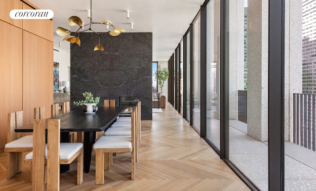 dining area featuring light parquet floors and a notable chandelier