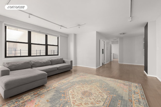 living room featuring dark hardwood / wood-style flooring and track lighting