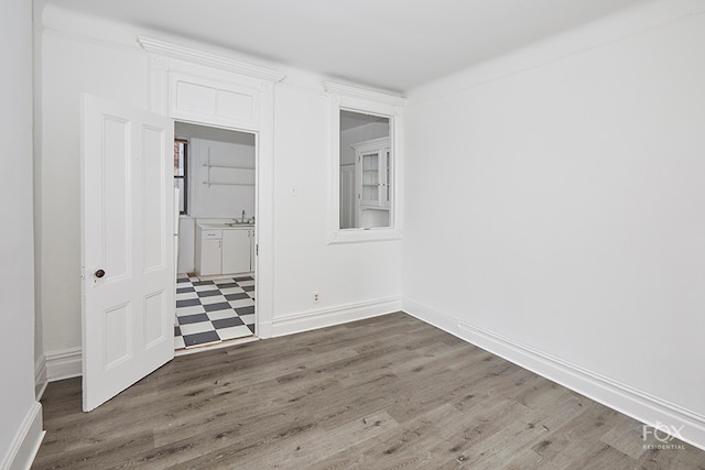 unfurnished bedroom featuring sink and dark hardwood / wood-style flooring