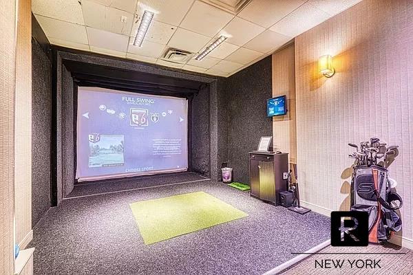 carpeted home theater with a drop ceiling