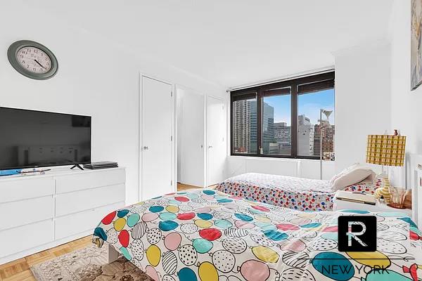 bedroom with light parquet floors