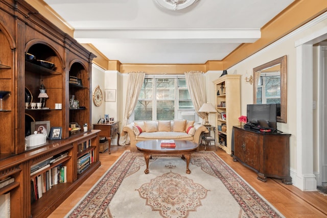 living area featuring beamed ceiling