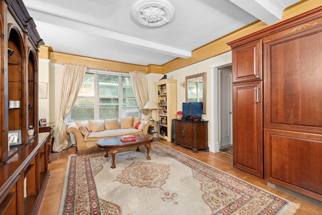 living area with beamed ceiling