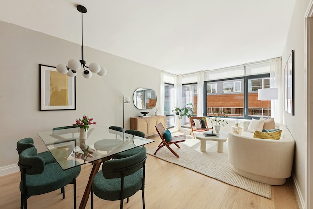 dining space with an inviting chandelier and light wood-type flooring