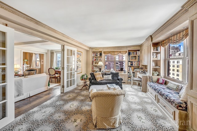 sitting room featuring crown molding, hardwood / wood-style flooring, and built in features