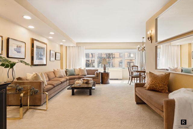 carpeted living room featuring a chandelier and a healthy amount of sunlight