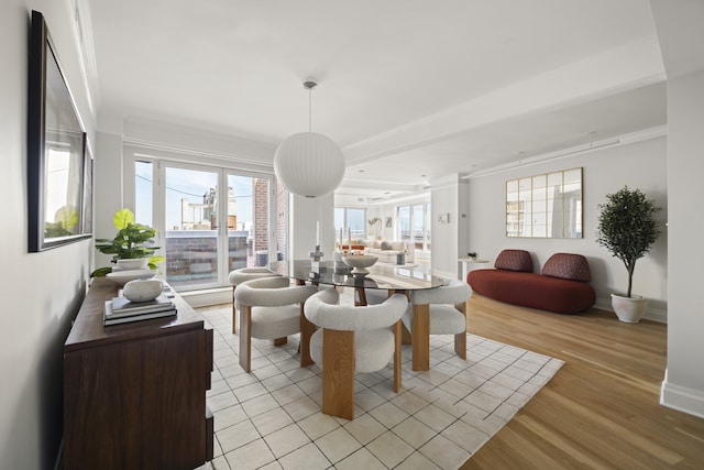 dining space with crown molding and light hardwood / wood-style flooring