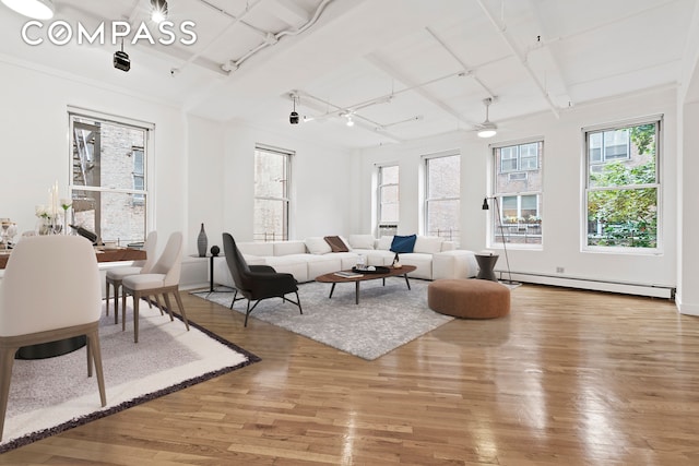 living room with light hardwood / wood-style flooring, ceiling fan, a baseboard heating unit, and track lighting