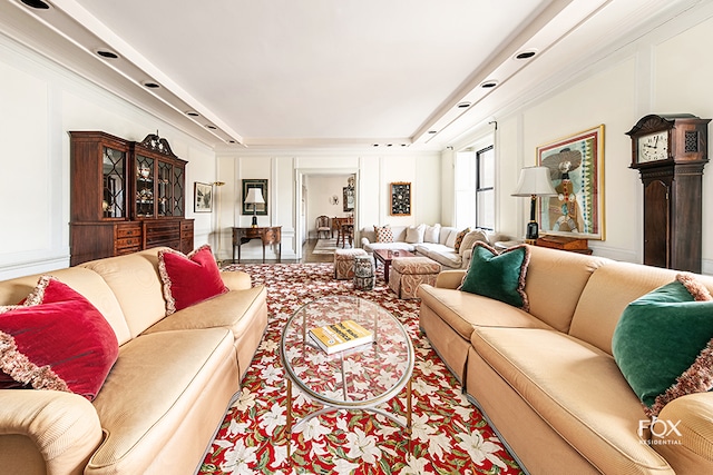 living room featuring tile patterned flooring and a tray ceiling