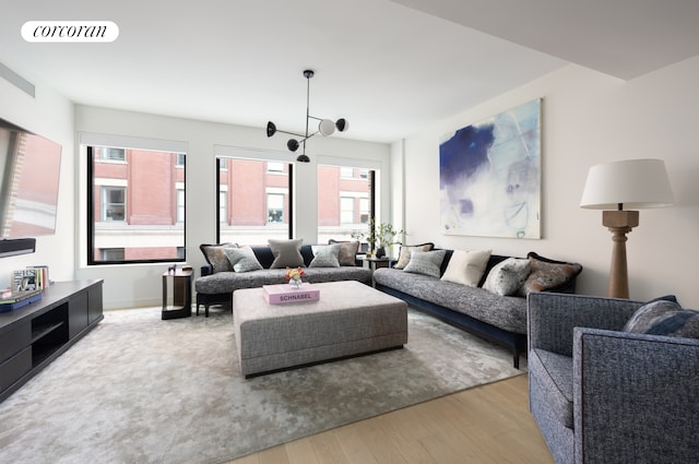 living room featuring light hardwood / wood-style flooring and a chandelier