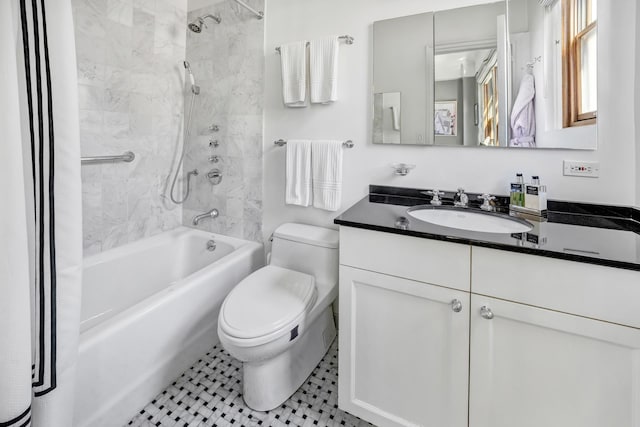 full bathroom with tile patterned floors, tiled shower / bath combo, vanity, and toilet