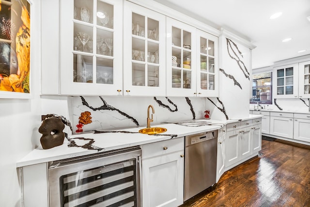 interior space with dark hardwood / wood-style floors, beverage cooler, white cabinets, decorative backsplash, and stainless steel dishwasher