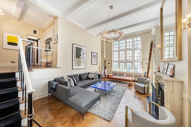 living room with beamed ceiling, a high end fireplace, and a wealth of natural light