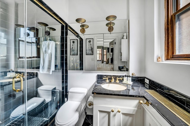 bathroom featuring vanity, toilet, and an enclosed shower