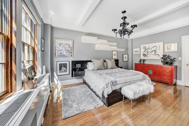 bedroom with light hardwood / wood-style flooring, beam ceiling, and a chandelier