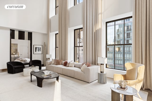 living room featuring a wealth of natural light and a towering ceiling