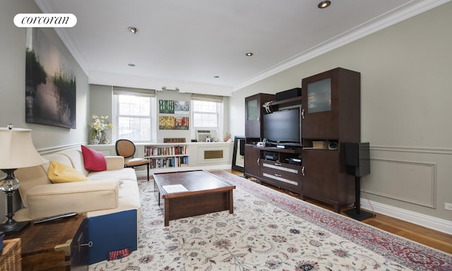 living room with wood-type flooring and ornamental molding