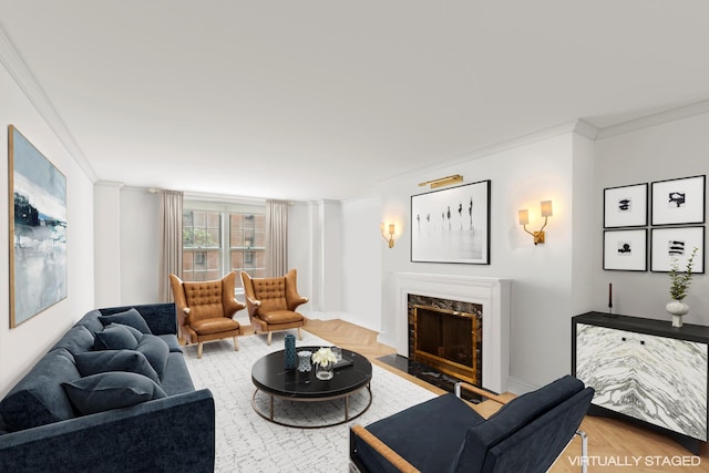 living room featuring a premium fireplace, ornamental molding, and parquet floors