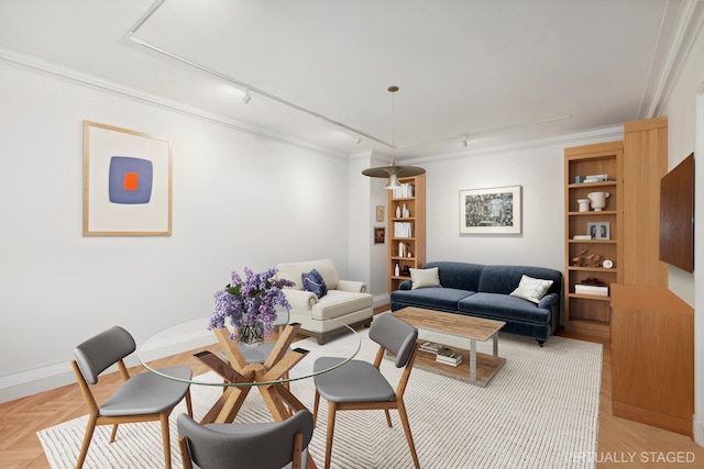 living room with ornamental molding, rail lighting, and light parquet flooring