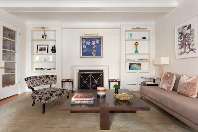 living room featuring crown molding, built in features, and hardwood / wood-style flooring