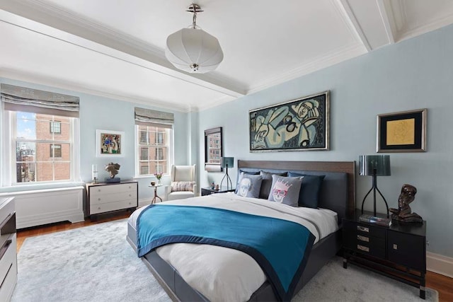 bedroom with beamed ceiling, wood-type flooring, and ornamental molding