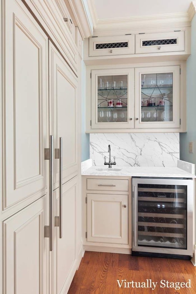 bar with backsplash, dark hardwood / wood-style floors, sink, and beverage cooler