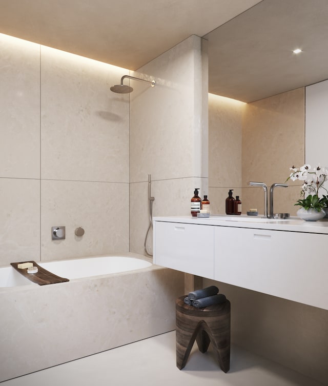 bathroom with concrete flooring and tile walls