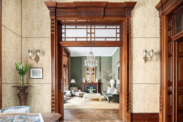 interior space featuring ornamental molding and a notable chandelier