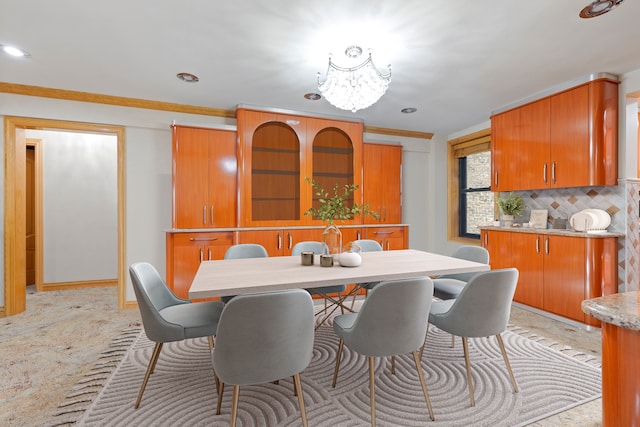 dining area with crown molding and light tile floors