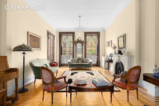 living area featuring light wood-type flooring and an inviting chandelier