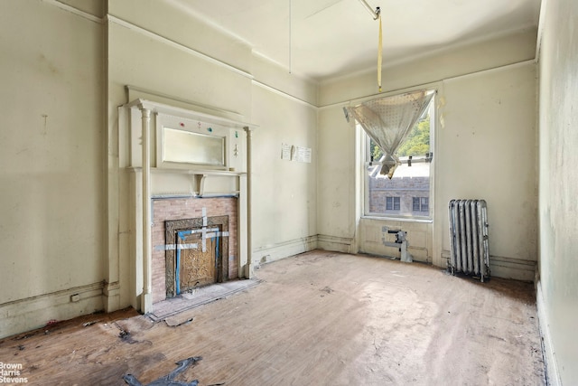 unfurnished living room featuring radiator