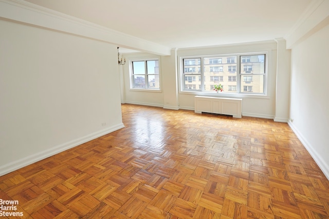 unfurnished room featuring light parquet floors, ornamental molding, and radiator