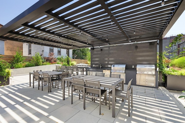 view of patio / terrace featuring grilling area, a pergola, and exterior kitchen