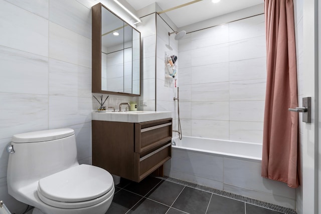 full bathroom with tile walls, shower / bathtub combination with curtain, vanity, tile patterned flooring, and toilet