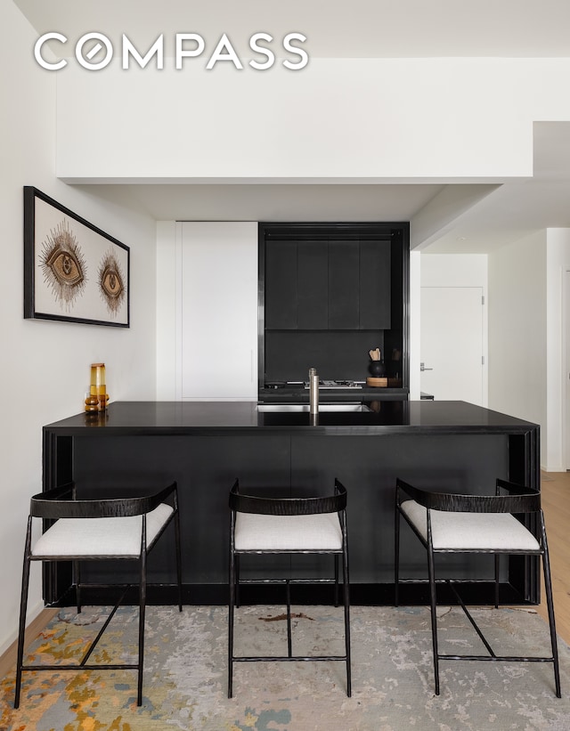 interior space featuring sink and light hardwood / wood-style flooring