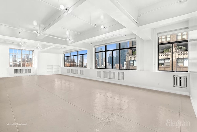 unfurnished living room featuring beam ceiling and concrete floors