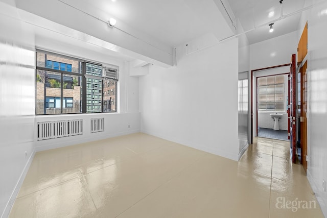 spare room with beam ceiling