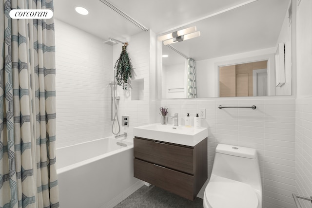 full bathroom featuring shower / bath combination with curtain, toilet, tile walls, and vanity