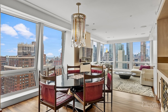 dining space featuring hardwood / wood-style floors and a chandelier