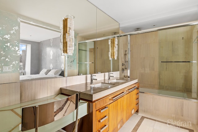 bathroom featuring tile flooring, bath / shower combo with glass door, and vanity