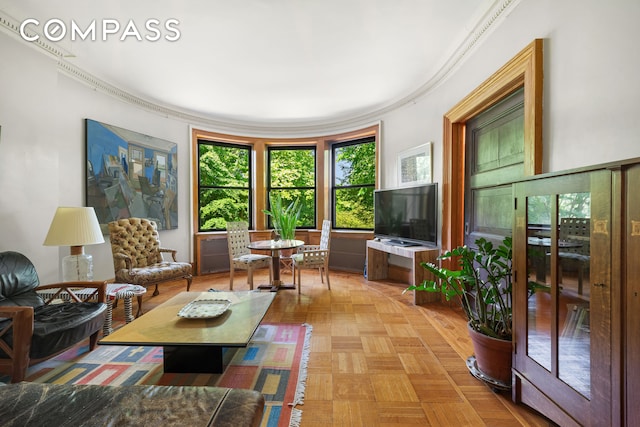 interior space with light parquet floors and ornamental molding