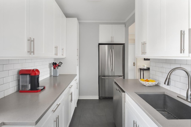 kitchen featuring stainless steel appliances, white cabinets, backsplash, and dark tile floors