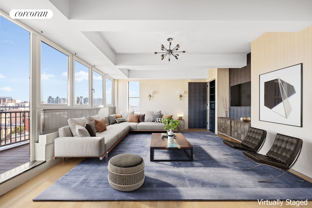 living room featuring an inviting chandelier and light wood-type flooring