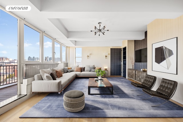 living room featuring light wood-type flooring and a chandelier