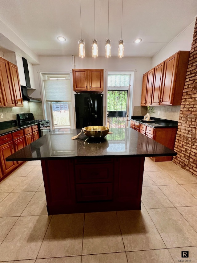 kitchen with tasteful backsplash, a kitchen island, and black appliances