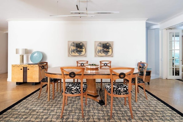 dining room featuring parquet flooring and ornamental molding