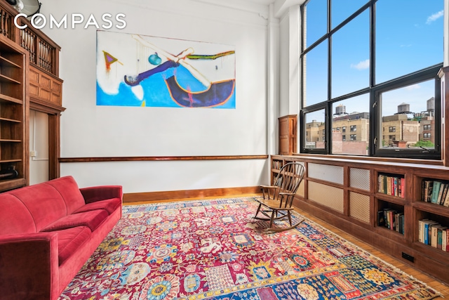 sitting room with wood-type flooring