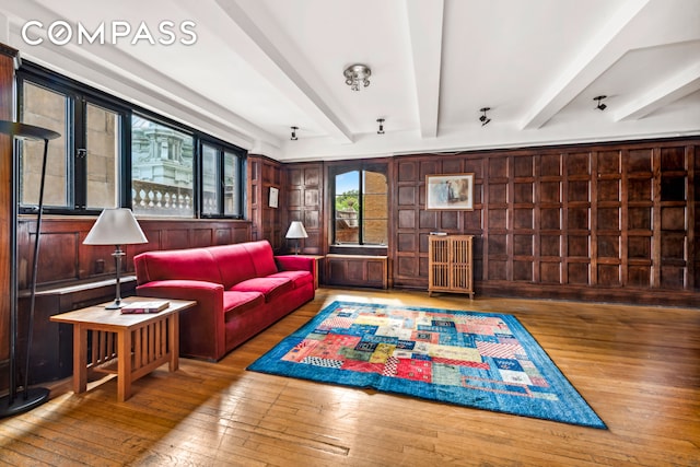 living room with beam ceiling and hardwood / wood-style flooring