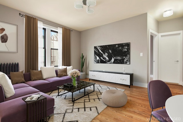 living room featuring wood-type flooring and radiator heating unit