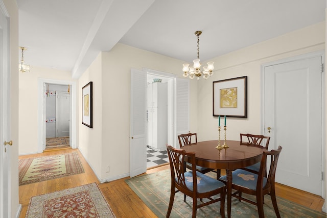 dining area featuring a notable chandelier and hardwood / wood-style floors